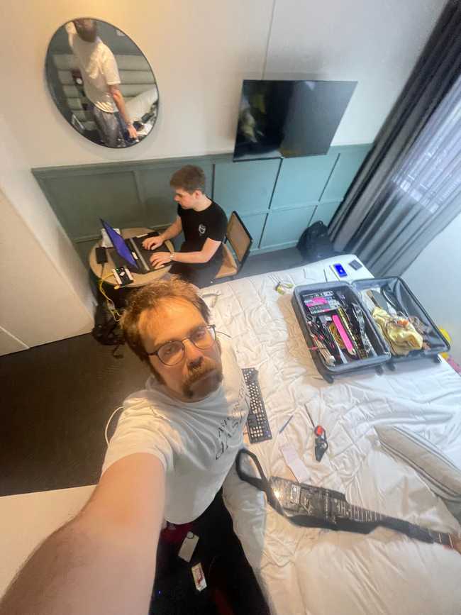 Coding from the Sydney hotel room, with our luggage bag we kept the set in, before dragging it in the street melted its wheels